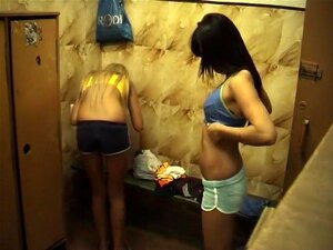 Tight Asian body is toweled after shower in dressing room